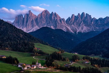 Night photo of Santa Magdalena village in front of the Geisler or Odle Dolomites Group.