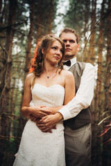 Fototapeta premium bride and groom in the forest of firs