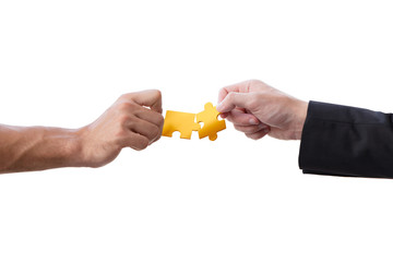 business male hand boss and staff connecting golden jigsaw puzzle isolated on white background