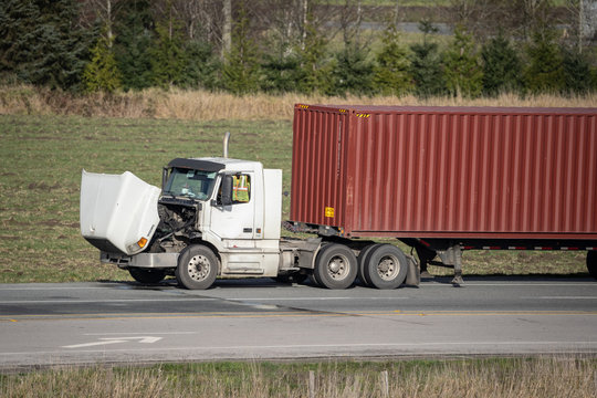 A Broken Semi Truck on the Side of the Road with its Hood Up