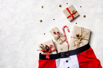 Santa Clause panties full of christmas gifts. Christmas concept gift card. Top view, copy space.