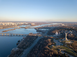 Beautiful urban landscape on the left, right banks of the Dnieper, Kiev, Ukraine, modern architecture against the blue sky on a sunny spring day