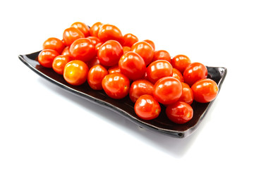 Fresh Tomato in a ceramic cup isolated white background 