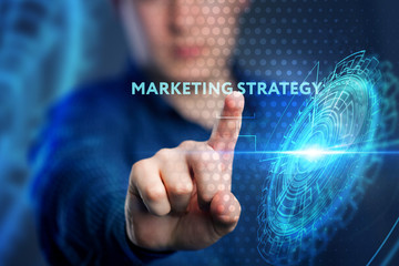The concept of business, technology, the Internet and the network. A young entrepreneur working on a virtual screen of the future and sees the inscription: marketing strategy