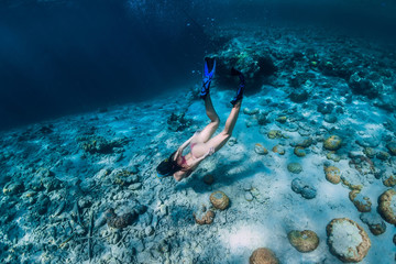 Woman freediver in bikini dive in the tropical ocean