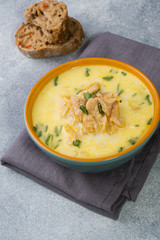 Pink salmon fish soup with cream in a ceramic bowl.
