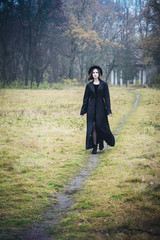 woman in a black coat on the road
