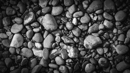 gravel with water texture natural abstract vignette dark black and white background close-up