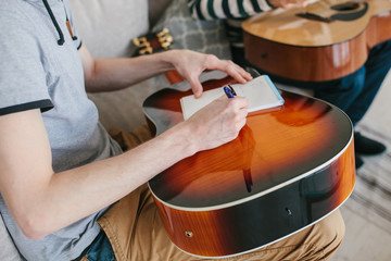 Learning to play the guitar. Interesting hobby or professional occupation of music. Music education or extracurricular activities or pastime