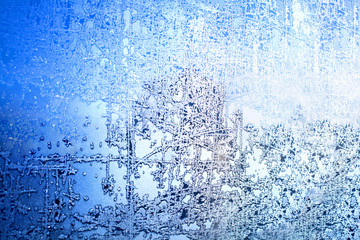 Frozen winter window, glass with frosty patterns, hoarfrost texture, snowflakes, New Year or Christmas ornament for banner, border, greeting card, blue and white background