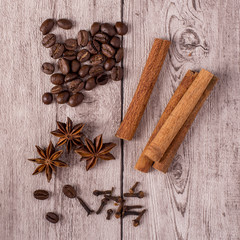 Spices and coffee beans on wooden table.