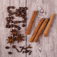 Spices and coffee beans on wooden table.
