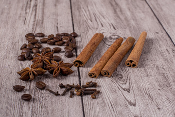 Spices and coffee beans on wooden table.