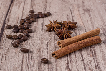 Spices and coffee beans on wooden table.