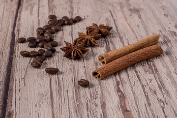 Spices and coffee beans on wooden table.