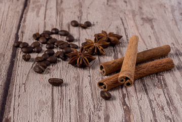 Spices and coffee beans on wooden table.