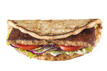 Greek pita with meat, salad, tomato and sauce isolated on white
