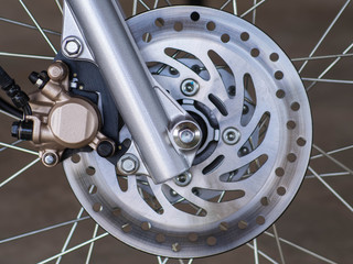 Front disc brake with wheel hub on motorbike. Close up of disc brake on motorcycle. Motorcycle car...