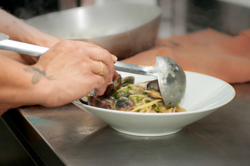 chef men prepares Italian pasta in the kitchen Italy,Basilicata, Lido Metaponto restaurant La Burkett, st. Jonio,1,August 25, 2018