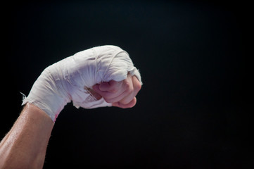  hand of fighter boxing lays ropes of ring