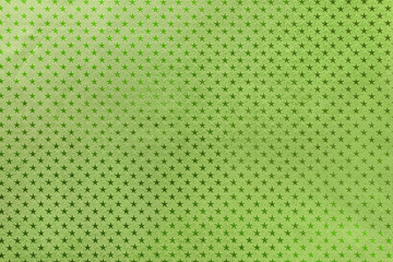 Dark green background from metal foil paper with a stars pattern
