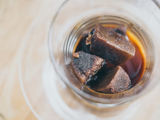 Coffee ice cubes in glass
