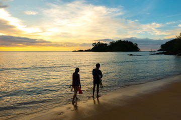 Happy Romantic Couple Enjoying Beautiful Sunset Walk on the Beach. Travel Vacation Retirement Lifestyle Concept..