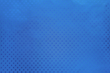 Blue background from metal foil paper with a stars pattern