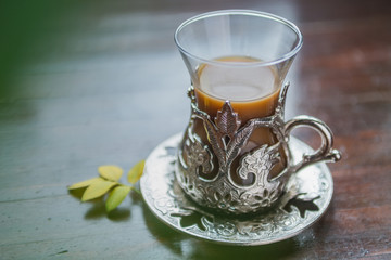 coffe in vintage turkish cup on wooden background top view