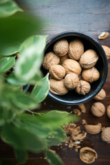 whole walnuts on wooden background top view healthy concept