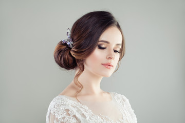 Romantic portrait of perfect bride with makeup and bridal hairstyle