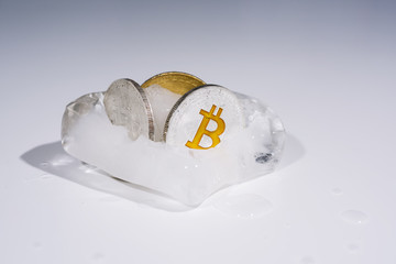 Abstract photo of cryptocurrency. Frozen coins in ice