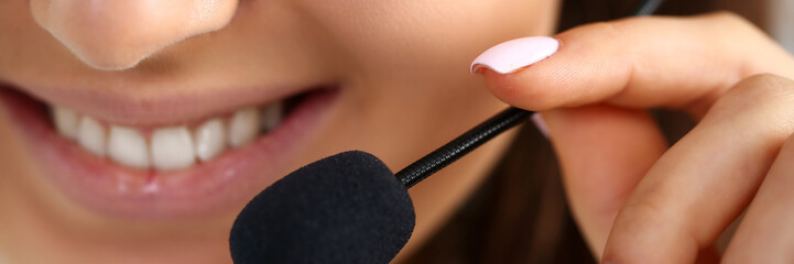 Call centre clerk at work hold in hand mic