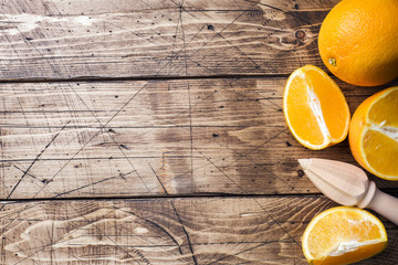 Pieces of fresh orange juice on wooden background. Copy space.