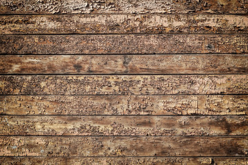 Texture of old brown wooden wall with cracked paint.