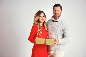 Man giving a christmas present to woman