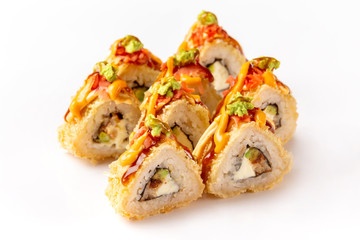 Hot tempura sushi rolls with eel, avocado and cream cheese served with teriyaki sauce isolated at white background.