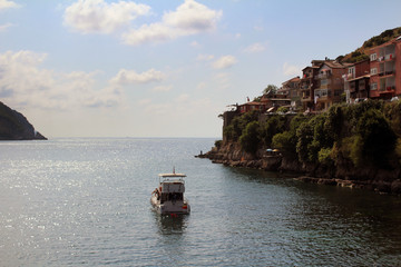 Amasra city. Between the rocks, the water stream and the boat.