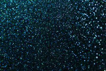 Dark blue sparkling background from small sequins, closeup. Brilliant backdrop