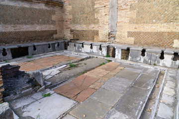 Ostia antica in Rome, Italy. Roman public latrine found in the excavations of Ostia Antica; unlike...