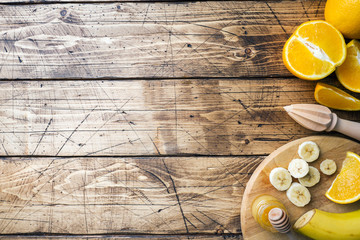Pieces of fresh orange juice on wooden background. Copy space.