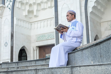Middle age muslim man praying at mosque.