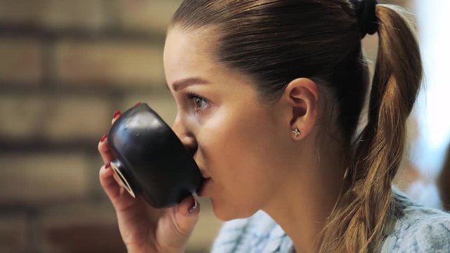 Profile of beautiful woman face listening an interlocutor in a cafe