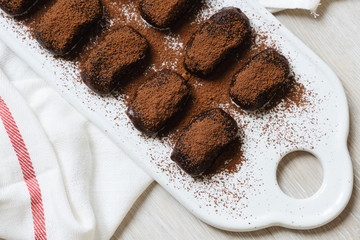 chocolate cake on a plate. cocoa. chocolate cake with coffee. chocolate and cookies. chocolate cake. white background and towel.