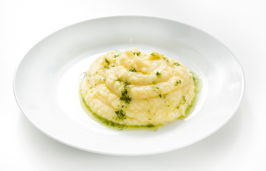 Mashed potatoes in a plate on a white background