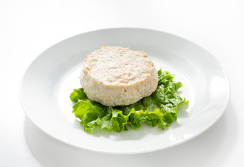 Meat cutlet in a plate on a white background