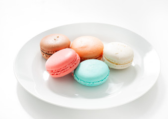 Macaroons dessert in plate on white background