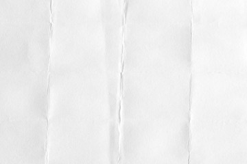 The texture of white paper with kinks. Background of crumpled cardboard.