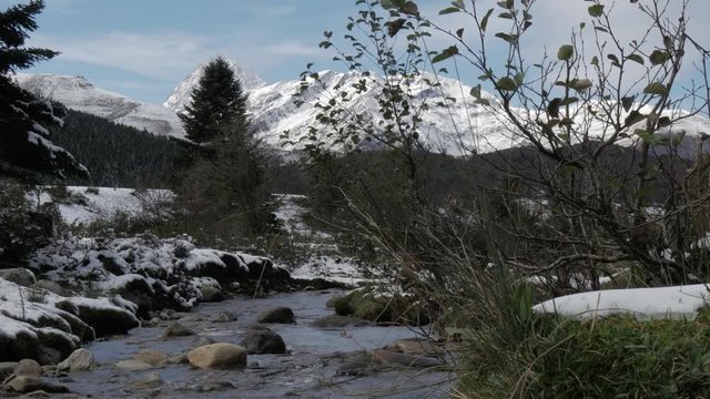 small river in the pyrenees mountains with Pic du Midi de Bigorre in background