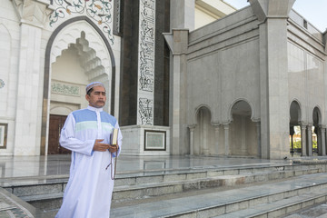 Middle age muslim man praying at mosque.